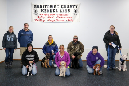Dogs and their owners posing for Obedience Training class photo